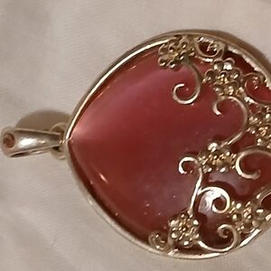 Elegant Red Pendant with Intricate Silver Detailing